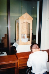 A boy praying in front of the Eucharistic Miracle of Dallas